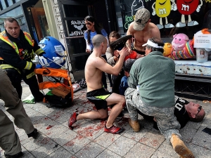 boston_marathon_explosion___bystanders_tend_to_an_injured_man_following_explosions_N2