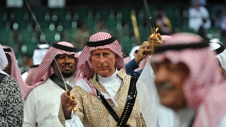 Britain's Prince Charles, wearing a traditional Saudi uniform, dances with a sword during the a traditional Saudi dancing, known as 'arda', which was performed during Janadriya culture festival at Der'iya in Riyadh