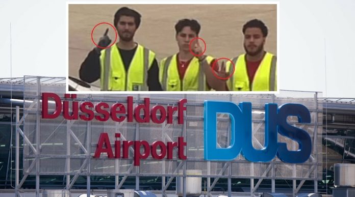 Mitten in der Ferienzeit posierten vor kurzem drei Mitarbeiter des Düsseldorfer Flugplatzes an einem Koffer-Rollband für ein skandalträchtiges Internet-Foto.